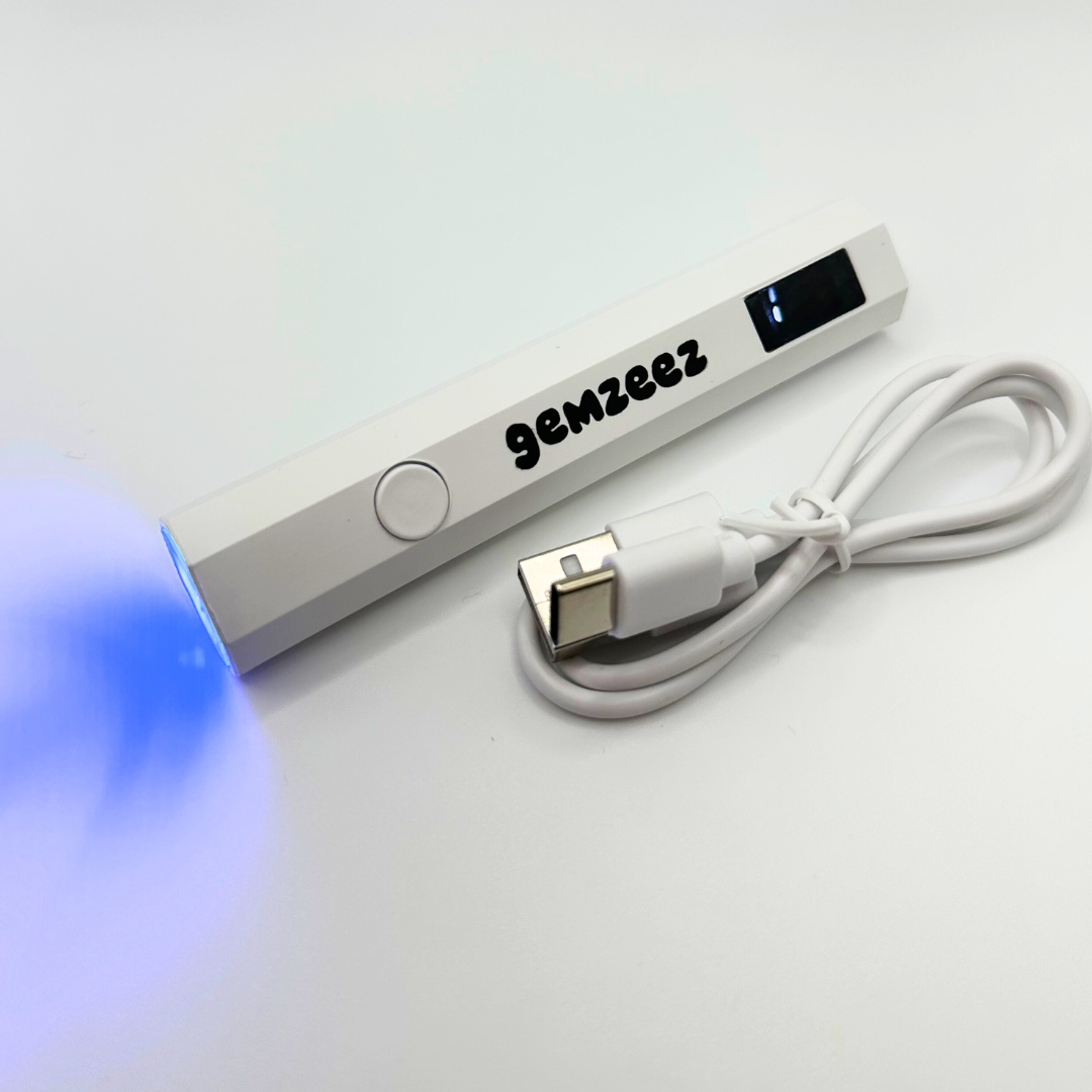 White electronic device with blue light and 'gemzeez' branding on a white background